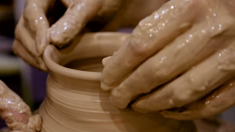 potter is making clay pot on the potter's wheel