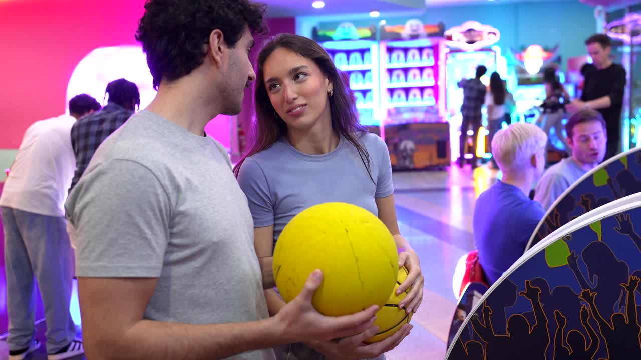 Couple kissing at an arcade