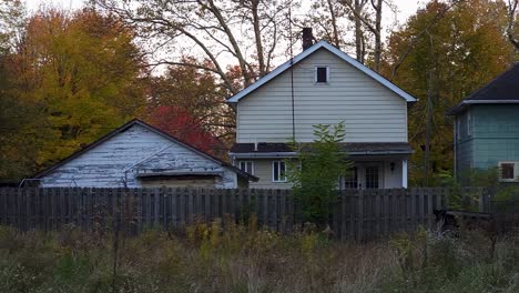 slider shot of old cottage design houses, trees in background in village