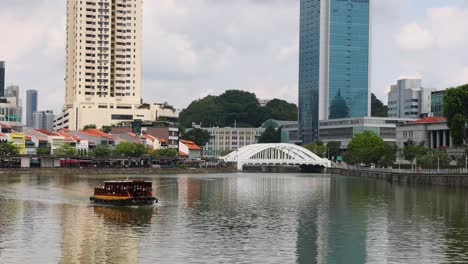 tourist boat cruising along a city riverfront.