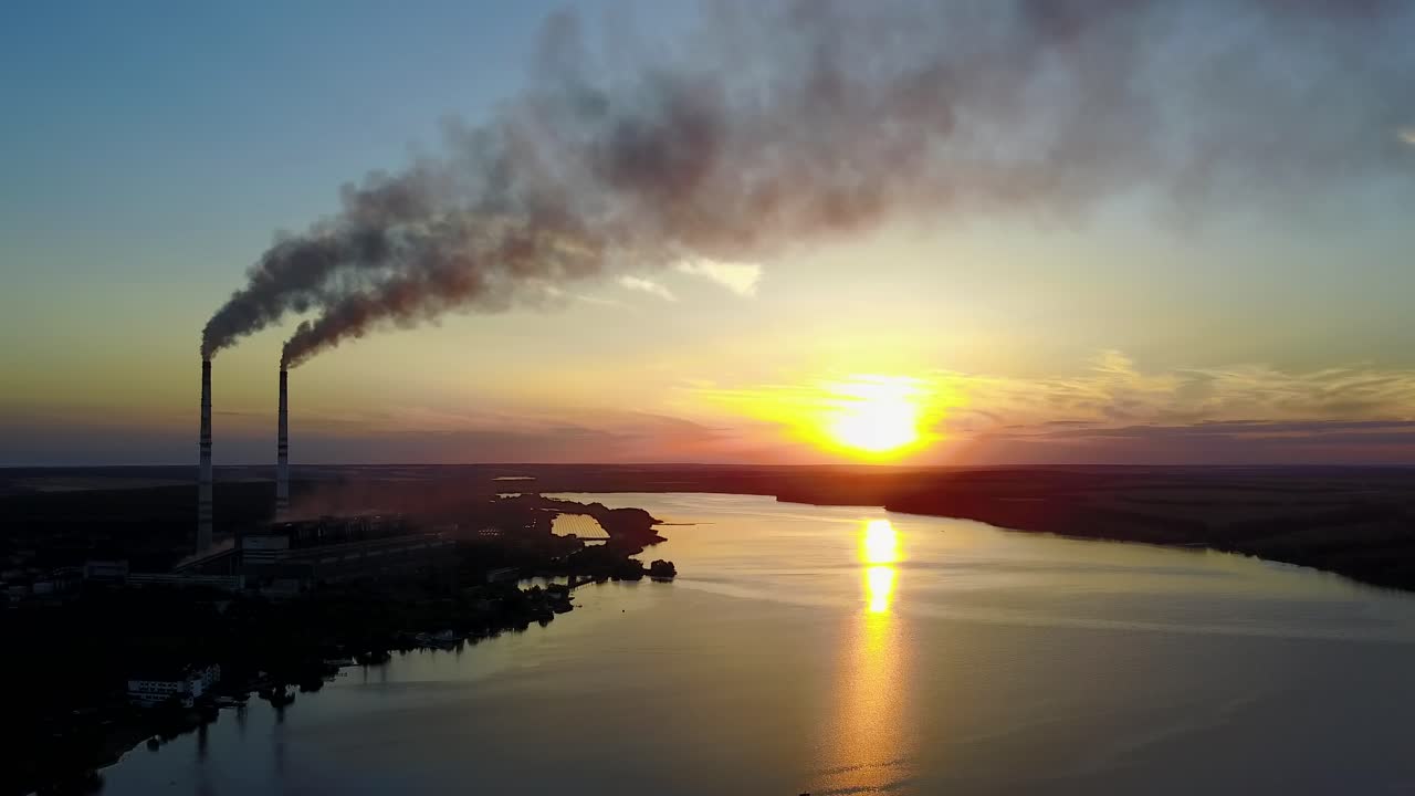 Factory pipe polluting air against sunset, environmental problems, smoke from chimneys
