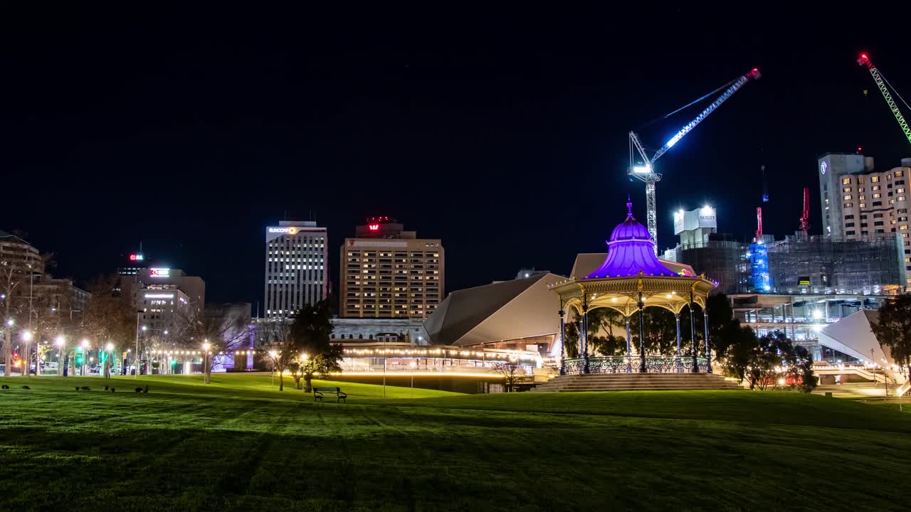 Timelapse of Adelaide city skyline at night from Elder Park with crane working in the background