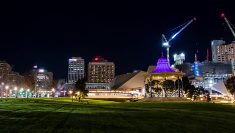timelapse of adelaide city skyline at night from elder park with crane working in the background