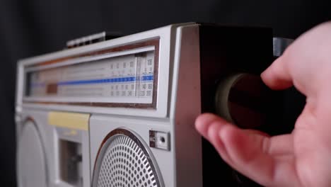 female fingers adjusting the frequency on an old vintage analog receiver