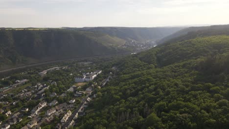 rotating aerial shot of cochem revealing the moselle river running through the whole of cochem, germany