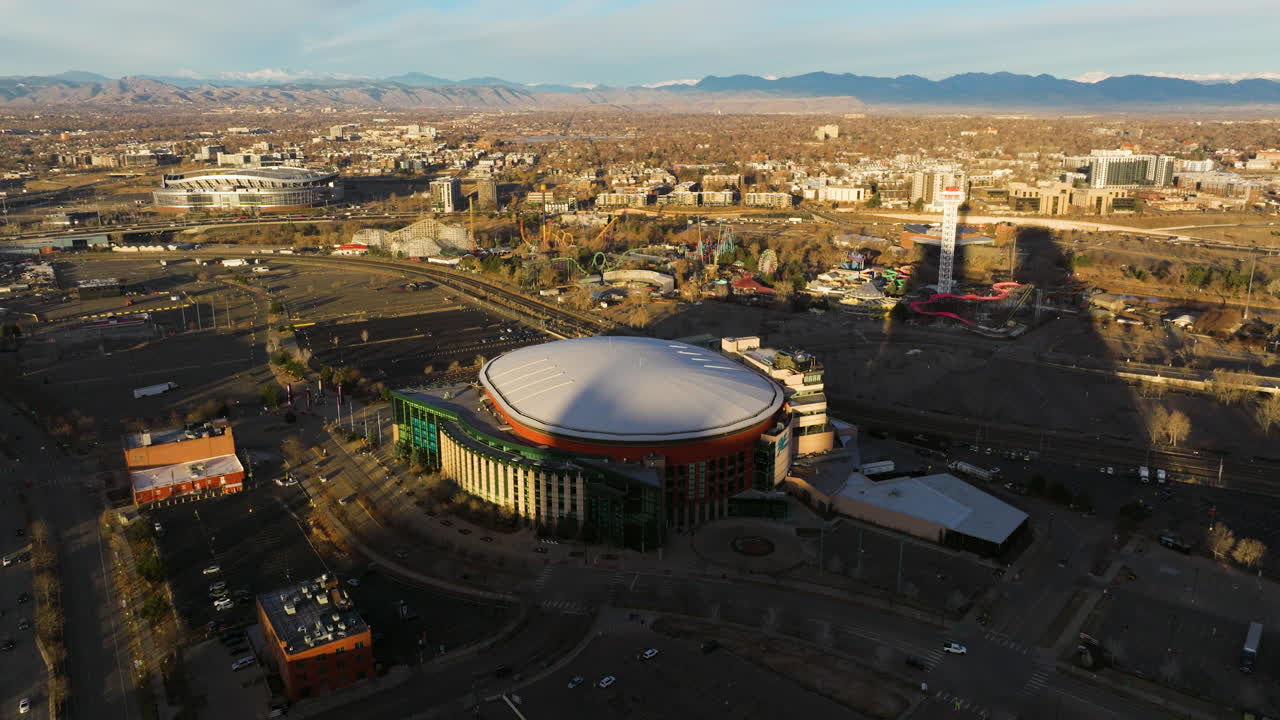 Drone view circling Ball Arena and downtown Denver skyline