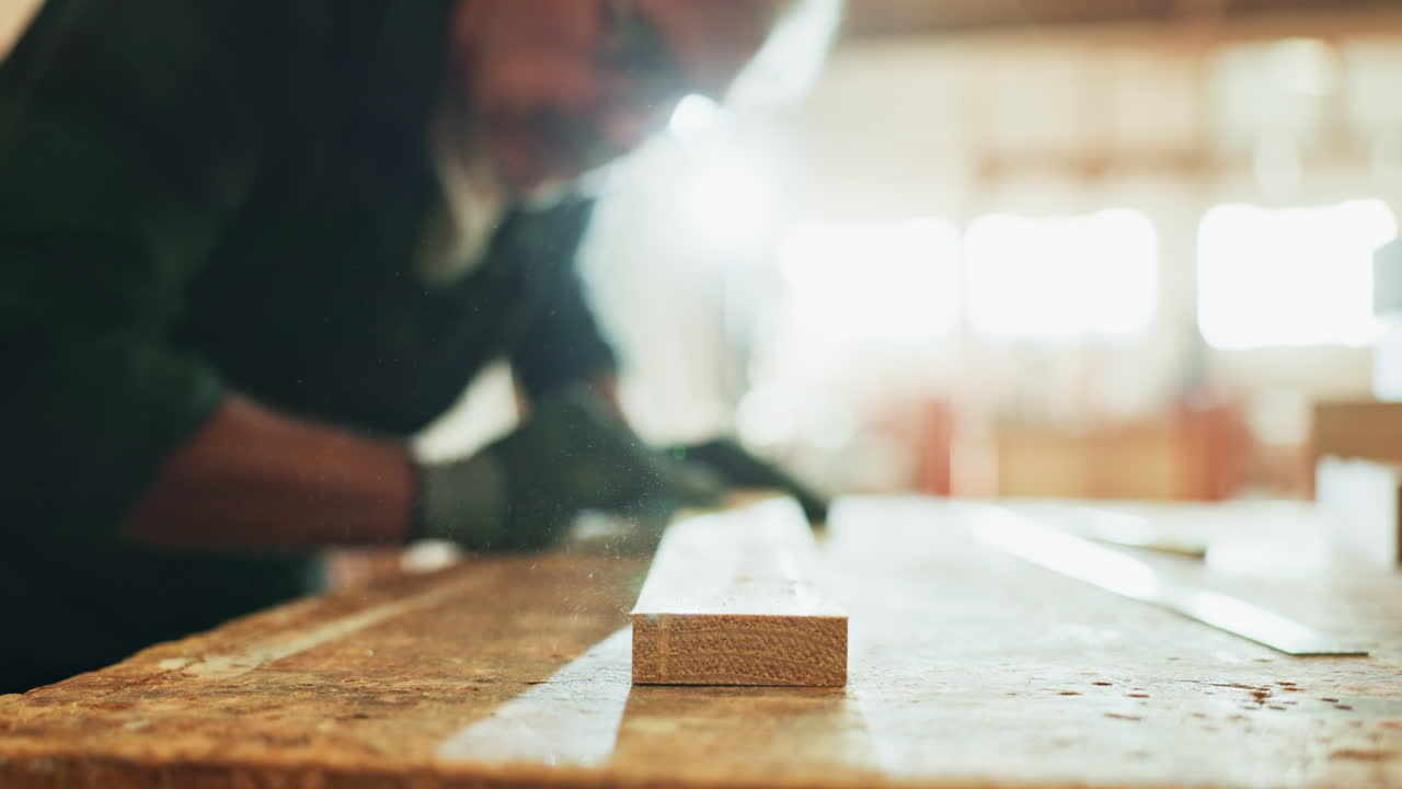 Senior man sanding wood in workshop