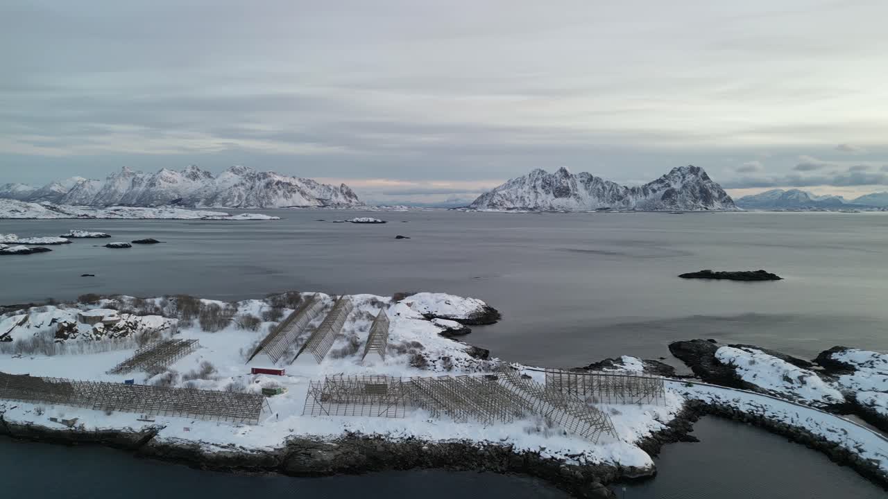 Snowy island and fjords at Svinøya, calm arctic winter, serene seascape atmosphere