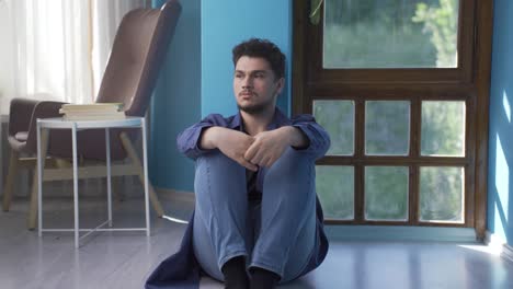 Exhausted-thoughtful-man-leaning-his-head-against-the-wall.