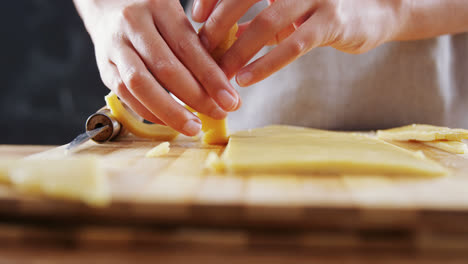 woman slicing dough on chopping board 4k