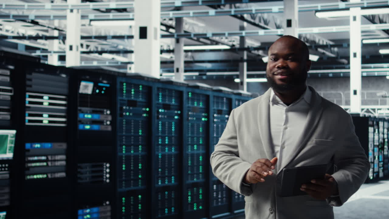 Vertical video Cheerful data center programmer using tablet to manage software updates