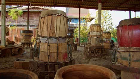 attaching animal skin to the front of the drum.