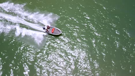 aerial overhead view of speeding boat across ocean off trinity beach in cairns