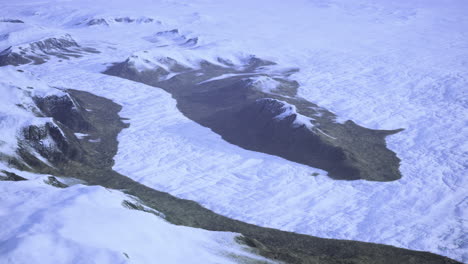 majestic aerial view of snow covered mountains and glacial valley in winter