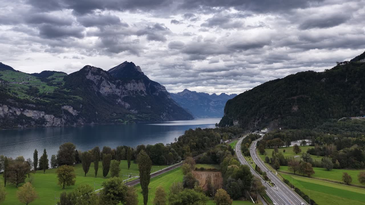 A wide aerial view of the deep blue Walensee, flanked by steep mountains near Walenstadt, Schweiz. Concept: Majestic Alpine scale and grandeur