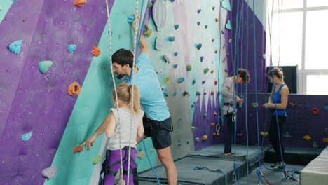 family rock climbing session at indoor gym