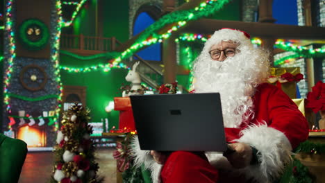 santa claus working on a laptop