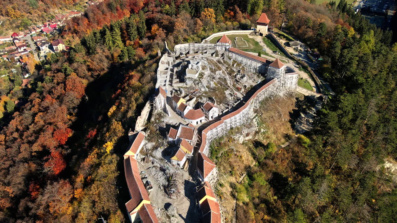 Aerial drone view of The Rasnov Fortress in Romania. Medieval fortress with Rasnov inscription on the top of the hill, tourists