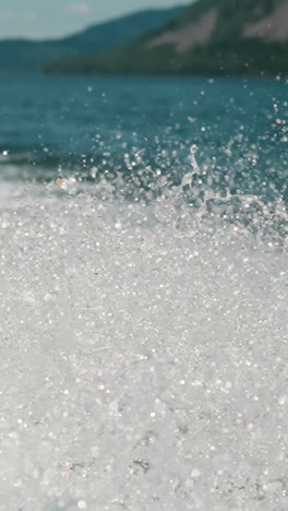 sparkling splashes on surface of lake after boat moving. picturesque landscape with foamy water surface. movement of water in natural reservoir slow motion