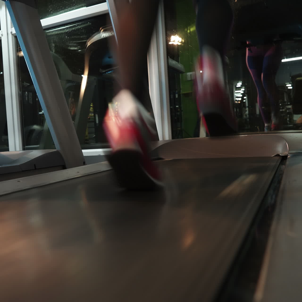Female muscular feet in sneakers running on the treadmill at the gym. Concept for fitness, exercising and healthy lifestyle. Square video