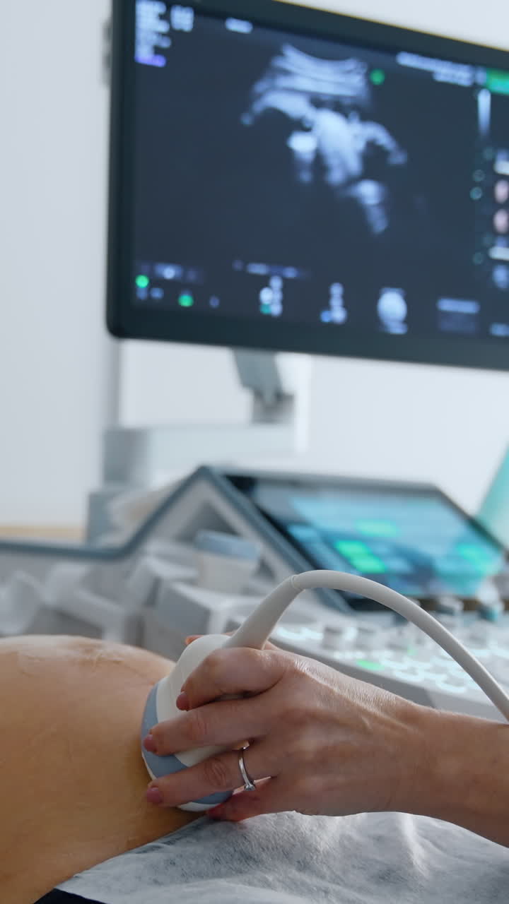 Belly examining in modern hospital. Ultrasound pregnancy diagnostic. Vertical video