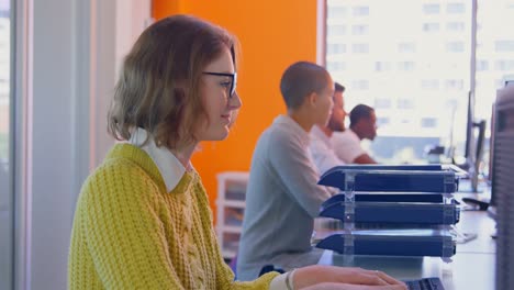 Side-view-of-Young-mixed-race-business-team-working-together-at-desk-in-modern-office-4k