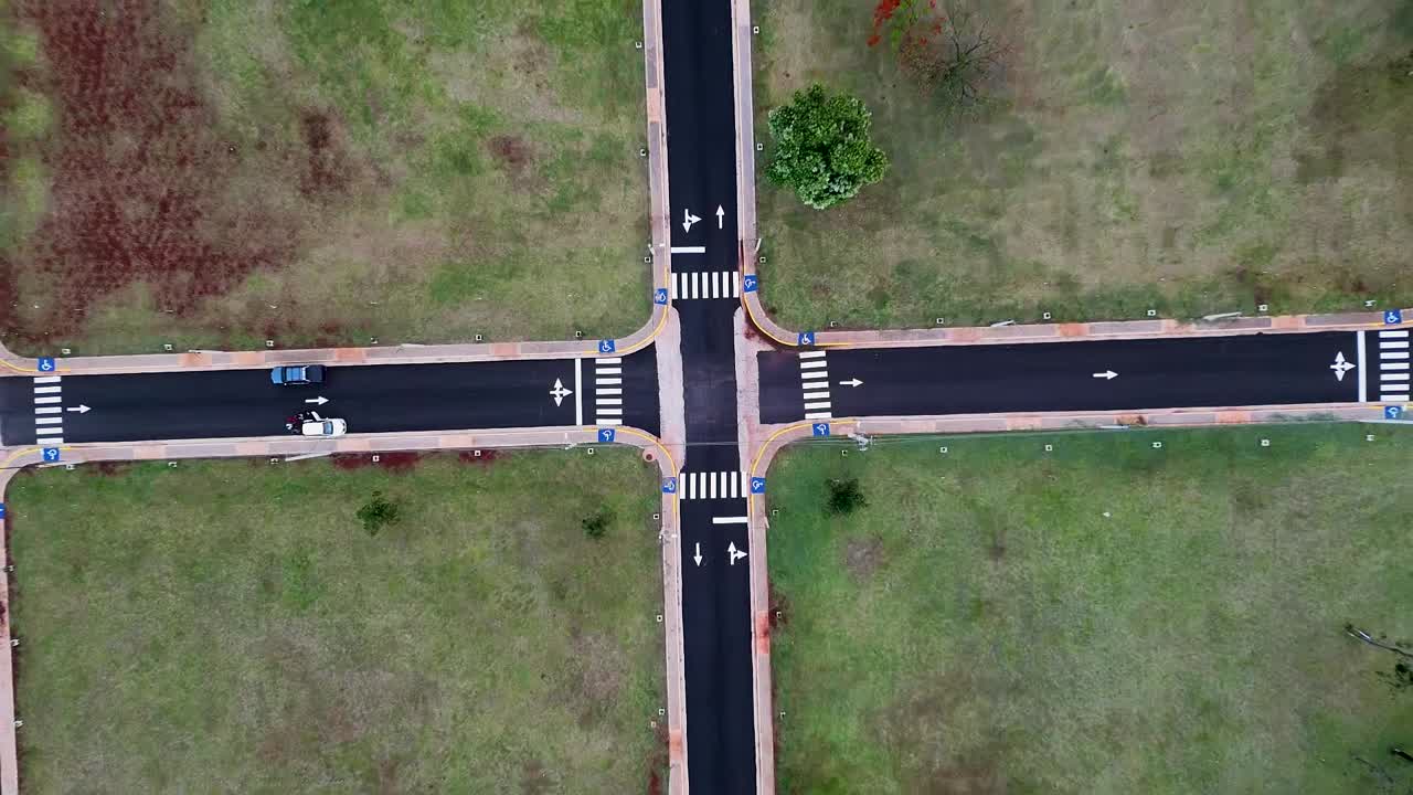 Top-down drone view of urban street grid forming symmetrical pattern in new housing lots construction, Posadas, Misiones, Argentina