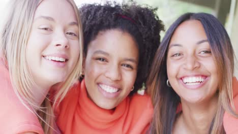 portrait of happy diverse teenager girls friends embracing at home, slow motion