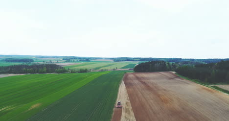 Tractor-Plowing-Field-In-Summer-