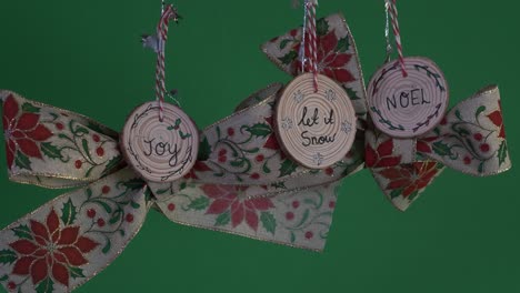 Hanging-Christmas-Bows-With-Holly-And-Mistletoe-Design-And-Wooden-Decorations