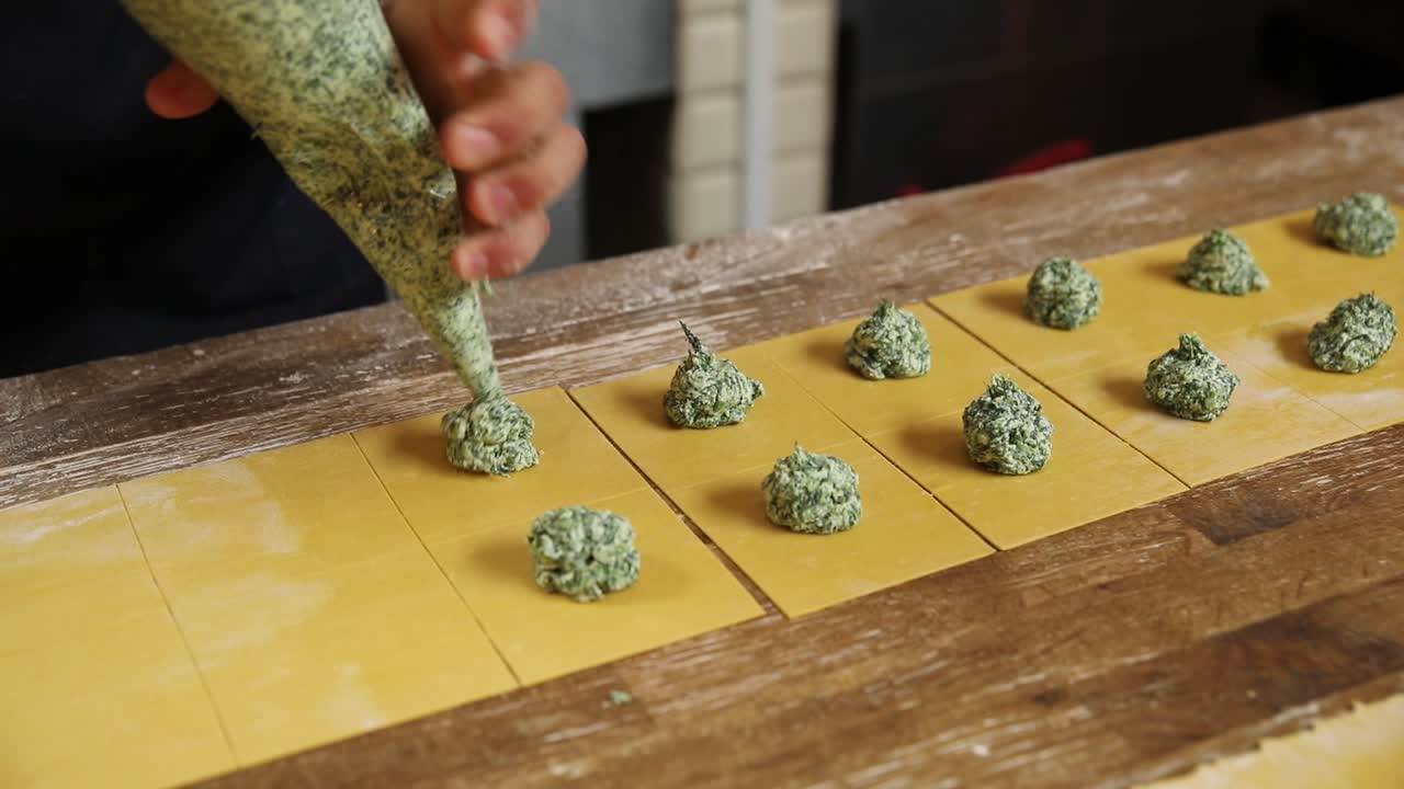 Chef che prepara ravioli di spinaci