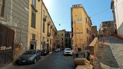 cobblestone street with parked cars and buildings