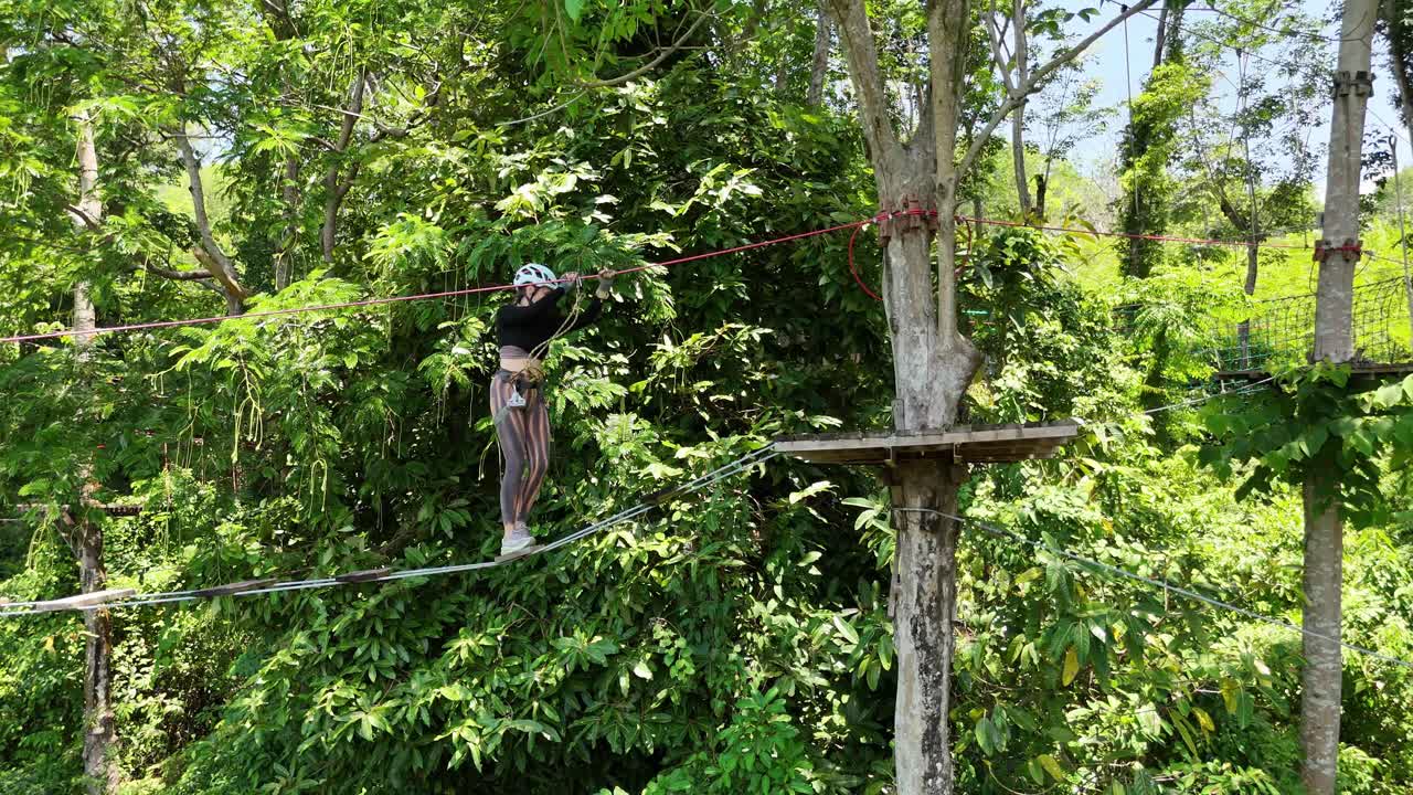 Woman Ziplining Through the Forest