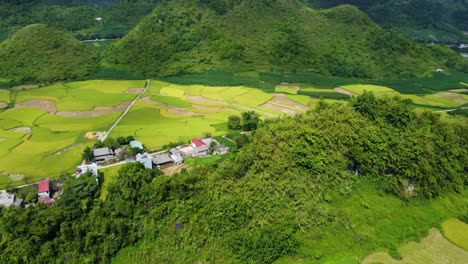 Small-settlement-on-the-way-through-Ha-Giang-Lopp,-Ha-Giang,-Mountain-range-background