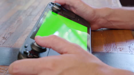 Ein-Steam-Deck-Handheld-Videospielsystem-Mit-Einem-Greenscreen-Display,-Das-Sich-Perfekt-Zum-Einfügen-Von-Benutzerdefiniertem-Filmmaterial-Eignet