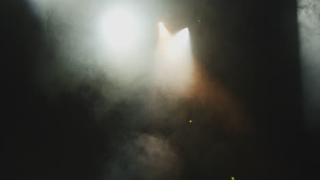 abstract textured smoke in slow motion in theatre spotlight. clouds of floating fog in theatrical stage light