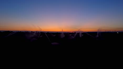 irrigation on a field at dusk - drone shot