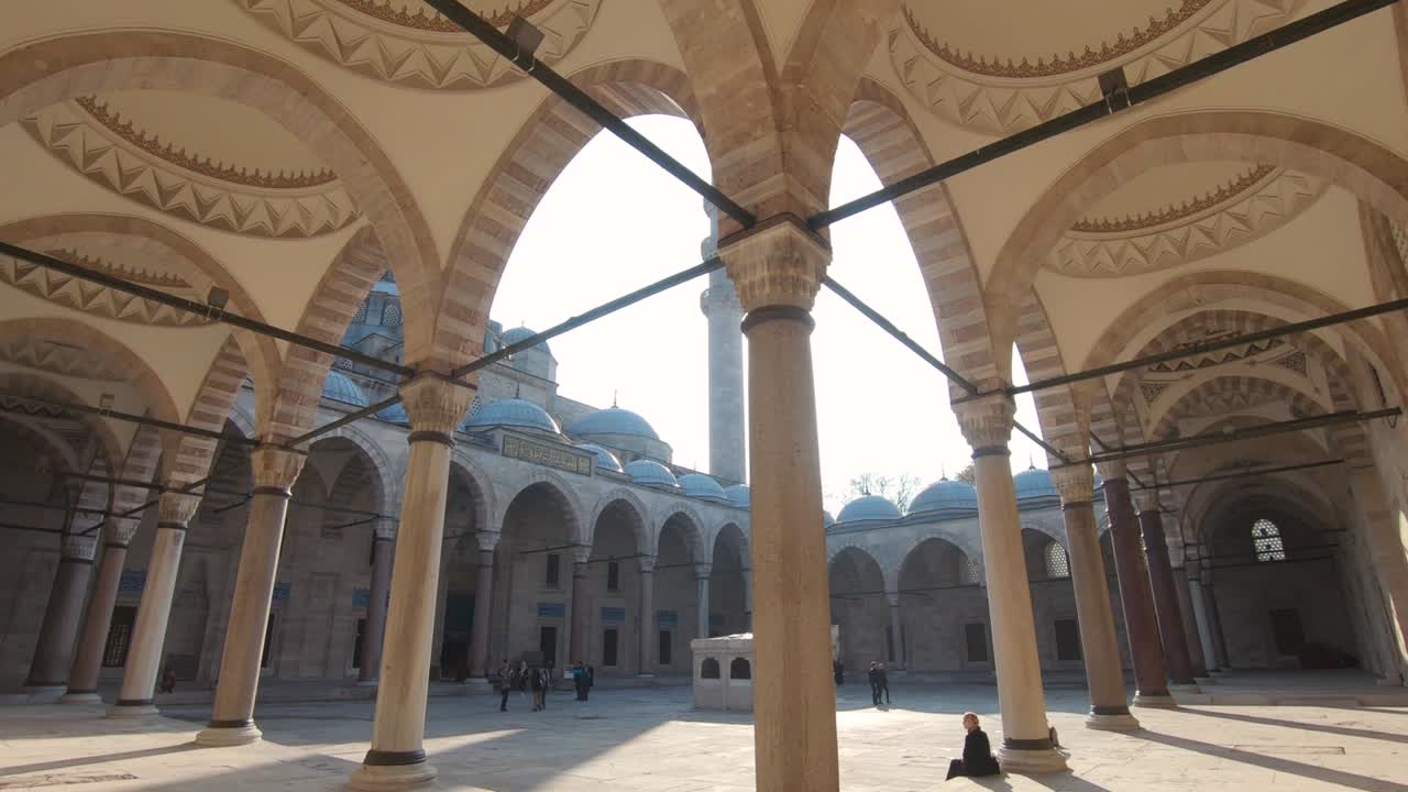 People at the courtyard of Suleymaniye Mosque, Istanbul, Turkey. Tilt down shot