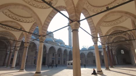 people at the courtyard of suleymaniye mosque, istanbul, turkey. tilt down shot