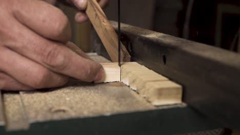 Close-up-shot-of-a-machine-that-is-cutting-wood-in-a-square-shapes