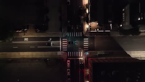 fort worth, texas traffic intersection at night with drone video moving down