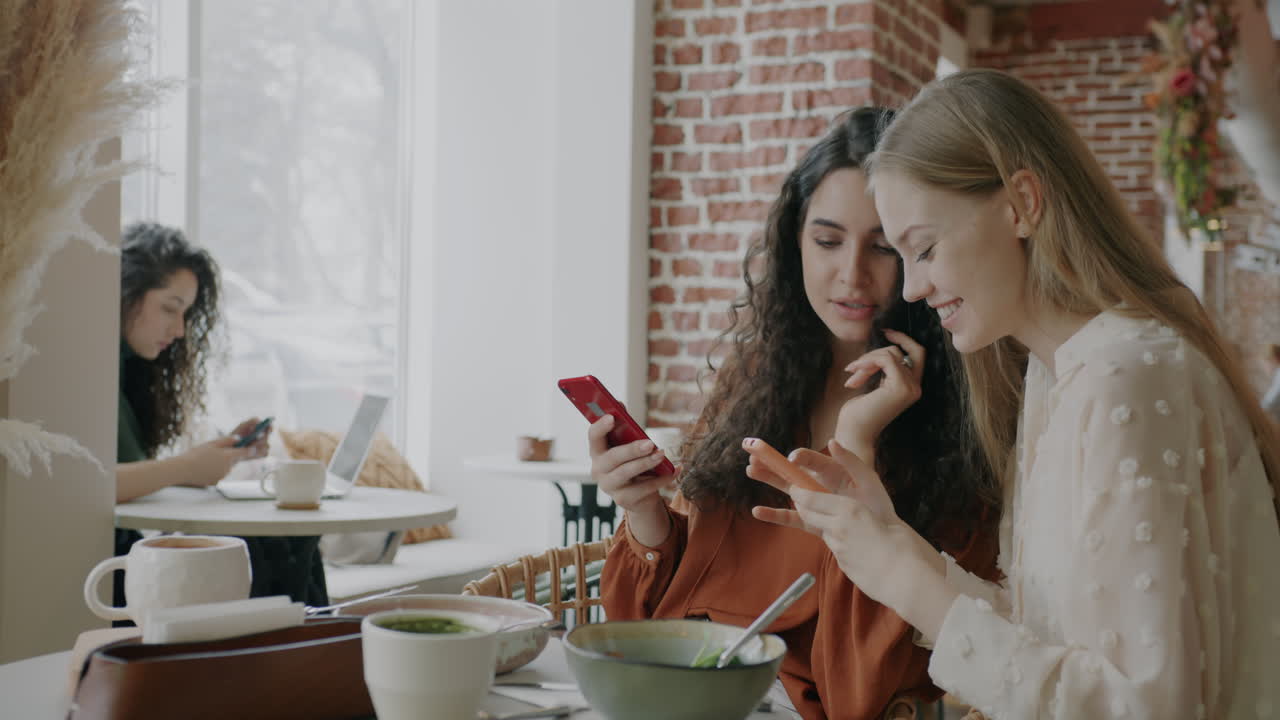 Women Friends Enjoying Lunch and Socializing at a Cafe