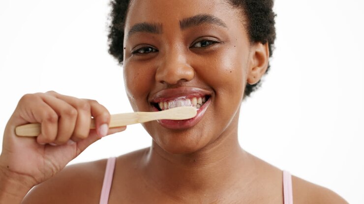 Woman Brushing Teeth with Bamboo Toothbrush
