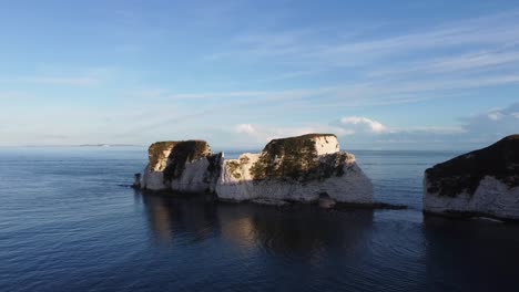 4K-Aerial-panoramic-landscape-drone-shot-of-the-cliffs-of-Old-Harry-Rocks,-in-Dorset,-on-the-English-coast-line-during-sunset