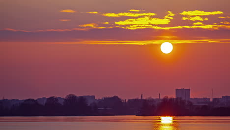 sunset time lapse of a port city with the golden glow reflecting off the ocean