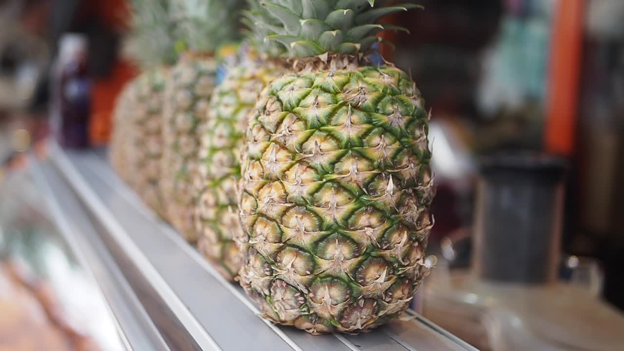 Fresh Pineapples Lined Up on a Market Display