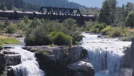 CP-Rail-train-with-tank-cars-rolls-east-past-Lundbreck-Falls,-Alberta