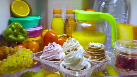 Sweet-cakes-in-the-open-refrigerator.