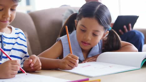 Girl-and-boy-doing-homework-in-living-room