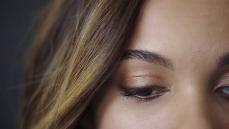 close up of beautiful hispanic girl eyes looking up at camera wearing makeup young feminine beauty